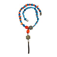 This limited edition long bold necklace is hand-crafted from natural blue howlite, turquoise, orange coral, and carnelian gemstones with goldtone metal inserts. Blue Howlite is a stone of patience and perspective. Turquoise can strengthen our connection to intuition, and it is also helpful for protection and purification. Carnelian is always keen to bring out your power. Coral is used to attract success and wealth and strengthens foresight. The necklace is for a playful but strong woman, whose d Bohemian Orange Jewelry For Meditation, Blue Long Necklace With Natural Stones As Gift, Blue Long Necklace With Natural Stones For Gift, Orange Amulet Style Necklace As A Gift, Orange Amulet Necklace For Gift, Long Necklace With Round Natural Stones For Gift, Turquoise Amulet Necklace With Natural Stones For Gift, Blue Gemstone Beads Long Necklace Gift, Turquoise Gemstone Beads Amulet Necklace Gift