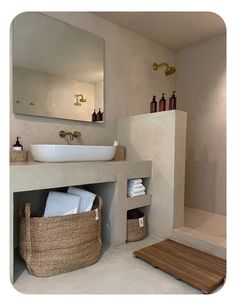 a bathroom with a sink, mirror and towel rack