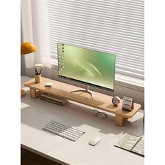 a computer monitor sitting on top of a wooden desk