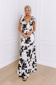 - Get ready for garden party season with this gorgeous maxi! Its abstract floral print and open back put a modern twist on classic style. - Let your chic style take center stage with this charming dress. - Black and ivory colored material with an abstract floral print - A built-in lining ending above the knee - Tie closure straps - A v-cut neckline - An open back with a tie accent - A waistline with an elastic banded back and back zip closure - A flowy yet flattering silhouette that ends in a ma Tea Garden Party, Party Maxi Dress, Abstract Floral Print, Tea Garden, Maxi Dress Party, Center Stage, V Cuts, Ivory Color, Abstract Floral