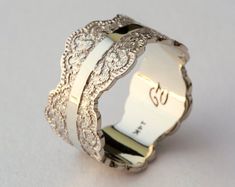 an intricately designed wedding band is shown with the number two on it's side