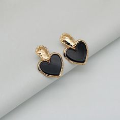 Discover Timeless Elegance Introducing our latest collection piece, the Black Heart Drop Earrings, a perfect blend of vintage charm and contemporary fashion. These earrings feature a classic heart shape, embodying love and elegance in every detail. Crafted from durable zinc alloy, they boast a glossy black finish that adds a touch of sophistication to any outfit. Ideal for women who adore fashion-forward accessories, these earrings are sure to make a statement at any event. Product Features Our Black Heart Drop Earrings are more than just a fashion statement. They are designed with the modern woman in mind, offering both style and comfort. The zinc alloy material ensures durability and long-lasting wear, while the heart-shaped design exudes romance and elegance. With their easy-to-wear dro Trendy Black Heart-shaped Earrings, Black Earrings For Valentine's Day, Black Metal Earrings For Valentine's Day, Black Heart Earrings As A Gift, Chic Black Heart-shaped Jewelry, Trendy Black Double Heart Jewelry, Black Heart Earrings For Pierced Ears As Gift, Trendy Black Heart Earrings For Gift, Vintage Black Jewelry With Heart Charm