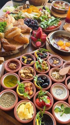 a table filled with lots of different types of food on it's trays