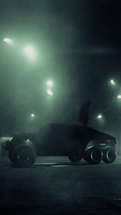 a black and white photo of a car at night