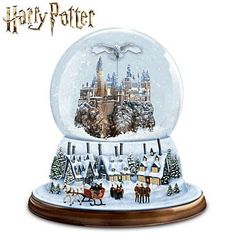 a snow globe with an image of hog potter's castle in the center and people on horses