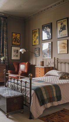 a bed sitting in a bedroom next to a window with pictures on the wall above it