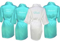 three robes with the names of bride and groom in black, white, and blue