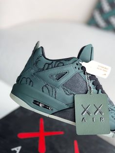 Embrace iconic artistry with the Air Jordan 4 Retro Kaws-inspired custom green sneakers. These statement shoes seamlessly blend the legendary Air Jordan silhouette with the distinctive flair of renowned artist KAWS. The monochromatic green colorway, featuring KAWS' signature "XX" motif subtly embossed throughout the upper, creates a unique and collectible look. Crafted with premium materials and meticulous attention to detail, these sneakers offer style and comfort. Step into the world of art an Luxury Air Jordan 4 With Cushioned Footbed, Green Custom Sneakers With Boost Midsole For Streetwear, Urban Green High-top Custom Sneakers, Urban Green Custom Sneakers For Streetwear, Green Urban Custom Sneakers For Streetwear, Jordan Silhouette, Jordan Retro 4, Fall Winter Jacket, Statement Shoes