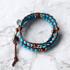 Turquoise magnesite and warm brown leather make up this striking double wrap bracelet. Perfect for layering or wear alone as a simple everyday piece. Features a high quality monstera leaf button closure. 6mm (.23") diameter turquoise magnesite stone beads 6mm copper round & 3mm silver cube accents Silver monstera leaf button, about 16mm (9/16") in diameter Warm brown leather Signature Bluefish logo heart charm 34 - 39 cm/13.5 - 15.5" length 2 button loop adjustments to fit most wrists Gift r Adjustable Hand Wrapped Leather Wrap Bracelet, Turquoise Hand Wrapped Wrap Bracelet, Adjustable Turquoise Leather Jewelry, Adjustable Leather Turquoise Jewelry, Logo Heart, Double Wrap Bracelet, Turquoise Leather, Leather Wrap Bracelet, Warm Brown