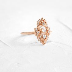 Round rose cut diamond focal: 3mm, SI clarity. This design features a closed basket setting on a delicate 1.2mm band—available in 14k solid yellow, white or rose gold. The setting is accented by twenty-five (1-2.2mm) round white diamonds. All accent diamonds are SI clarity and G+ color. We handcraft each piece with responsibly sourced 14k gold and ethically sourced stones. Fine Jewelry Wedding Diamond Ring With Rose Cut Diamonds, Delicate Crystal Ring With Rose Cut Diamonds For Wedding, Delicate Rose Cut Diamond Crystal Wedding Ring, Delicate Crystal Wedding Ring With Rose Cut Diamonds, Elegant Rose Cut Diamond Crystal Ring, Heirloom Style Rose Gold Cluster Ring, Heirloom Rose Cut Diamond Promise Ring, Fine Jewelry Rose Gold Rose Cut Diamonds, Rose Gold Rose Cut Diamonds Fine Jewelry