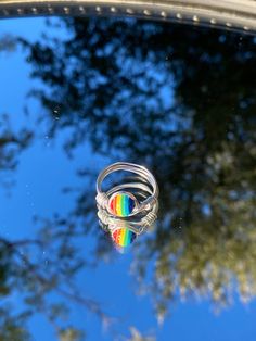 This is a handmade wire ring with a rainbow pride stone. This comes in a variety of sizes and band colors. Made in Arizona. Handmade Adjustable Rainbow Jewelry, Adjustable Rainbow Sterling Silver Jewelry, Adjustable Multicolor Nickel-free Rings, Handmade Rainbow Round Jewelry, Rainbow Wire Wrapped Round Jewelry, Handmade Round Rainbow Jewelry, Handmade Rainbow Colored Ring Jewelry, Handmade Rainbow Jewelry Ring, Handmade Rainbow Ring Jewelry