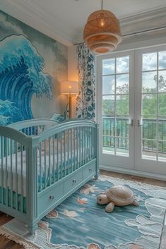 a baby's room decorated in blue and white with a turtle rug on the floor