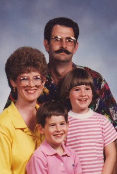 an older man and two young boys posing for a photo with glasses on their faces