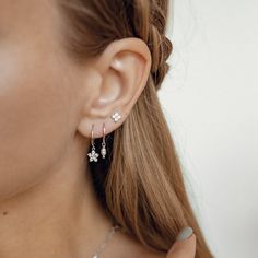 This pair of huggie earrings is made from 925 sterling silver and features a smooth hoop with a small flower (a floweret) pendant hanging from their lower edge, embellished with 6 tiny zirconia stones. They open and close with a hinged opening, also on the lower edge, and have a thin earpiece that threads comfortably through the earlobe. A timeless, graceful design that will work with a huge array of styles.  Also available in 18k gold plated sterling silver: https://www.etsy.com/listing/1067338248/floweret-huggie-earrings-gold-plated 🎁 Packaging: Beautifully packed in a box, ready for gifting. 🏷️ This product is made of sterling silver -- easily recognizable by its '925' stamp of authenticity. It is also hypoallergenic, making it suitable for people with sensitive or irritable skin. We Slogan Tees, Huggie Earrings Silver, Daisy Studs, Slip Dresses, Small Earrings Studs, Natural Pearl, Huggie Earrings, Sterling Silver Studs, Earrings Sterling Silver