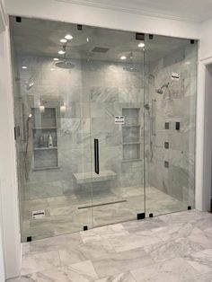 a walk in shower sitting inside of a bathroom