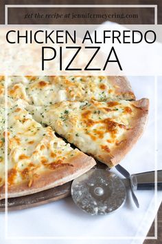 the chicken alfredo pizza is cut into slices