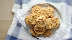 a bowl filled with cookies on top of a blue and white checkered table cloth