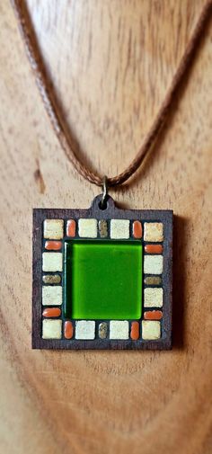 Beautiful pendant with a striking green glass tile in the center, surrounded by mini Moroccan ceramic tiles.   A nice addition to dress up your favorite outfit! Set in a square wood bezel. *Design exclusive to Nikki Sullivan Mosaics* Green Glass Tile, Mosaic Pendant Necklace, Handmade Glass Square Pendant Jewelry, Luxury Green Artisan Beads, Gems, And Cabochons, Outfit Set, Glass Tile, Green Glass, Ceramic Tiles, Pendant Necklaces