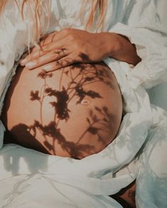 a pregnant woman's shadow on her stomach