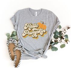 "Hello Pumpkin Shirt, Womens Fall Shirts, Fall Tshirt, Retro Fall Graphic Tees, Vintage Inspired T shirts, Autumn Tshirts, Pumpkin Tee Shirt Our Hello Pumpkin shirt makes the perfect addition to your fall collection - also makes a great gift! How we make our shirts - This shirt is made with a professional DTG Printing machine. Printed with eco-friendly water based inks that prints the image/designs on the shirt allowing the image to become part of the shirt so there is no peeling or cracking ove Womens Fall Shirts, Fall Tshirts, Fall Shirts Women, 70s Shirts, Fall Graphic, Texas Shirts, Patches Shirt, Autumn T Shirts, Thanksgiving Shirt