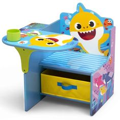 a child's desk with a toy shark on it