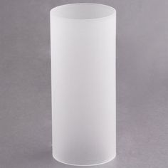 a white vase sitting on top of a table