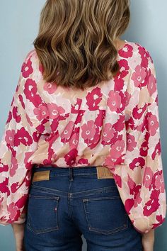 Add some flower power to your wardrobe with the Blooming Bridget Blouse Top. This quirky top boasts a playful and fun vibe with its unique design and versatile fit (available in sizes S-XL). Get ready to turn heads and make a statement with this must-have blouse top! -fits true to size Trendy V-neck Floral Print Blouse, Trendy V-neck Blouse With Graphic Print, Feminine Floral Print Stretch Tops, Feminine Stretch Floral Print Tops, Trendy Stretch Printed Blouse, Playful Spring Printed Blouse, Playful Printed Spring Blouse, Playful Printed Blouse For Spring, Playful Printed Multicolor Blouse