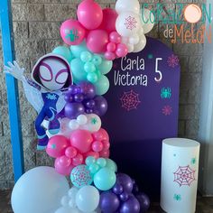 balloons and decorations are displayed in front of a sign