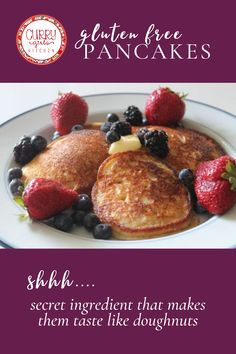 pancakes with berries and blueberries are on a white plate that says gluten free pancakes