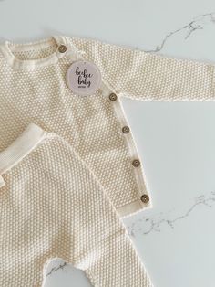 Get ready for cuteness overload with our baby sweater and pants set! Featuring a textured pattern, this long sleeve sweater has buttons on the side for easy dressing. The matching pants have an elastic waistband for a comfortable fit. Perfect for your little one's playful adventures! Cozy Playtime Sets For Fall, Soft Knit Long Sleeve Sweater For Playtime, Cozy Long Sleeve Sweater For Playtime, Cream Long Sleeve Sets For Fall, White Long Sleeve Sets With Button Closure, Fall Long Sleeve Sets With Button Closure, Beige Long Sleeve Sets With Buttons, Baby Sweater, Our Baby