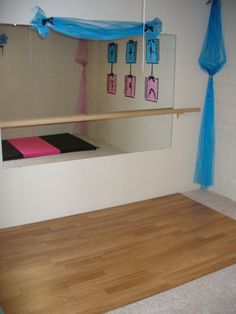 a room with a mirror, yoga mat and wall hangings