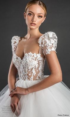 a woman in a wedding dress posing for the camera with her hands on her hips