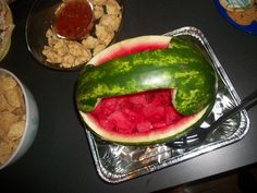 a watermelon is cut in half and placed on top of other food items