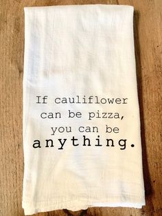 a tea towel with the words if cauliflower can be pizza, you can be anything