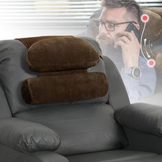 a man sitting in a recliner talking on a cell phone with his headphones up to his ear