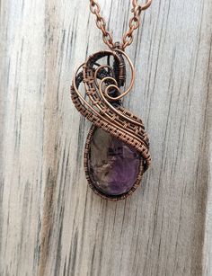 This necklace is an Ametrine cabochon wrapped in copper weaves, and aged. I've been having so much fun making these weaves and learning more with each necklace. I try to show my passion in each of my necklaces and this one is no exception. The stone is so clear and has beautiful colors, which are complimented by the copper wire. Over all a gorgeous and unique necklace. Like all my pieces, this necklace is a one of a kind piece, and once it's gone, it's gone. Artisan Amethyst Wire Wrapped Necklaces, Unique Purple Copper Necklace, Bohemian Oval Hand Wrapped Necklaces, Bohemian Oval Hand-wrapped Necklaces, Bohemian Hand-wrapped Oval Necklace, Handmade Purple Copper Wire Necklace, Handmade Purple Necklace With Copper Wire, Hand Wrapped Purple Copper Necklace, Purple Copper Pendant Necklace