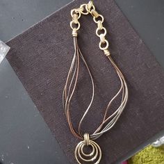 Gold And Brown Leather Cord Necklace With Removable Enhancer To Give Multiple Looks. Elegant Brown Metal Jewelry, Elegant Necklaces With Lobster Clasp For Accessorizing, Chic Brown Formal Jewelry, Chic Brown Round Jewelry, Elegant Brown Necklace With Lobster Clasp, Elegant Brown Necklace With Adjustable Chain, Chic Brown Metal Jewelry, Elegant Brown Jewelry With Adjustable Chain, Leather Cord Necklace