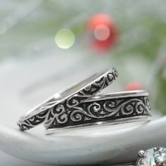 "This Sterling Silver Matching Couples Ring Set has a beautiful curling pattern that continues around the length of both the wide and narrow band. We are happy to create this beautiful band set for you in a variety of ring sizes and finish options! For the Narrow Band: This delicate and narrow Sterling Silver Smoke Swirl pattern band has a beautiful, curling design that is a wonderful compliment for everything from filigree to modern styles. It measures 2.5 mm (about .1 inch) in width and is 1.5 Curling Pattern, Rings For Couples, Matching Couple Rings, Couples Ring, Handmade Wedding Rings, Silver Wedding Band, Promise Rings For Couples, Couples Ring Set, Sterling Silver Wedding Band