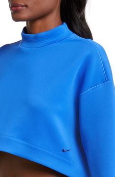 An oversized mock-neck sweatshirt features moisture-wicking Dri-FIT techology that keeps you comfy, while a cropped length creates a cool, modern look. 15 1/2" front length; 18" back length (size Medium) Mock neck 93% polyester, 7% spandex Machine wash, tumble dry Imported Versatile Funnel Neck Top With Ribbed Cuffs, Nike Athleisure Sweatshirt For Spring, Nike Cropped Activewear For Sports, Nike Oversized Activewear For Streetwear, Nike Oversized Sporty Activewear, Nike Oversized Long Sleeve Activewear, Nike Cropped Activewear, Oversized Nike Athleisure Activewear, Spring Activewear With Ribbed Waistband And Long Sleeves