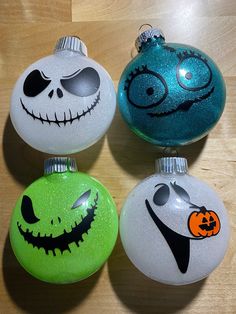 three christmas ornaments with faces painted on them