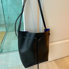 Mansur Gavriel Bucket Bag, Black With Electric Blue Interior, New Never Worn. Pristine Condition. Comes With Pouch Inside And Dust Bag. Designer Black Bucket Bag For Everyday, Formal Blue Bucket Bag With Adjustable Strap, Blue Formal Bucket Bag With Detachable Strap, Mansur Gavriel Bucket Bag, Blue Interior, Mansur Gavriel, Electric Blue, Black Blue, Bucket Bag