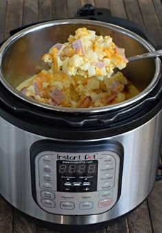 an instant pot filled with food on top of a wooden table