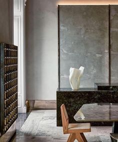 an elegant dining room with marble table and chairs