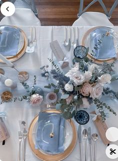 the table is set with silverware, flowers and napkins for an elegant dinner