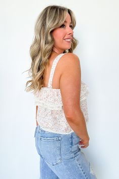 Details: Stay flirty and fun with our Floral Ruffle Flounce Tank Top! The Ditsy Cropped Top boasts a relaxed fit and a ruffle layer accented with delicate lace trims. Perfect for a romantic date or a sunny day out.- Ruffle flounce - FloralContent: 100% RayonSize + Fit: Models are 5'4" and wearing a Small - Measurements from a size Small - Full length: 18" - Chest: 24"-38" - Waist: 40" Brand: Olivaceous Spring Tops With Ruffled Straps In Flirty Style, Flirty Ruffled Tops For Day Out, Flirty Ruffled Strap Tops For Day Out, Flirty Tops With Ruffle Hem For Vacation, Flirty Tops With Ruffled Straps For Day Out, Casual Tops With Lace Trim And Ruffled Straps, Flowy Ruffled Flirty Tops, Flirty Flowy Ruffled Tops, Fit Models