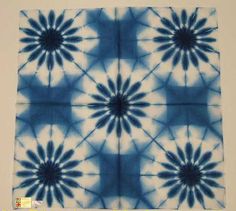 a blue and white tie - dyed square design