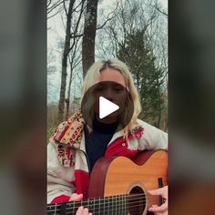 a woman holding a guitar in front of her face