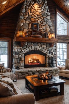 a living room filled with furniture and a fire place in the middle of a stone fireplace