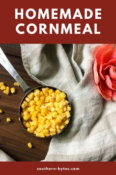 a bowl filled with corn next to a flower