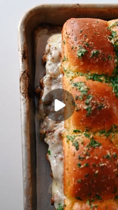 a pan filled with meat and cheese covered bread